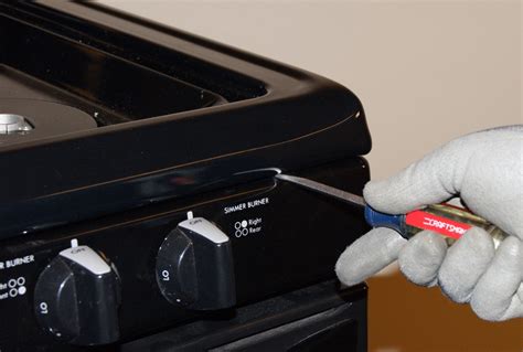 how to open the top of a kenmore gas stove